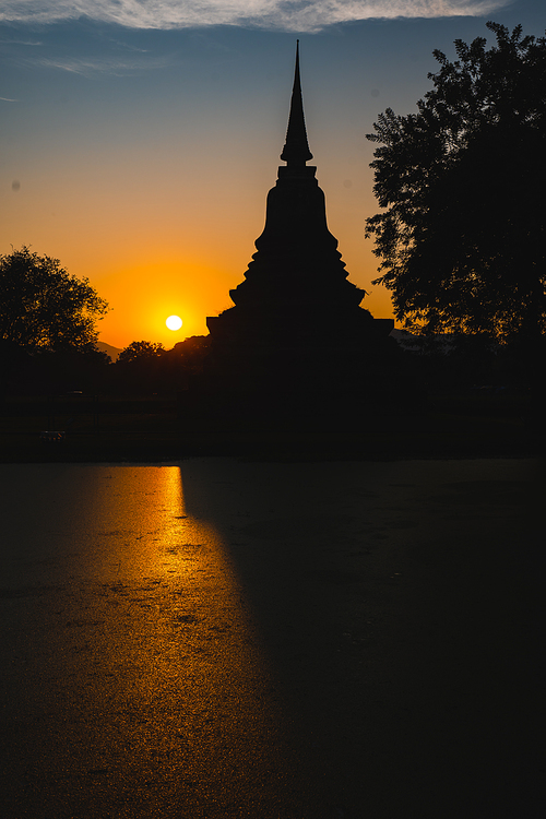 Historic Town of Sukhothai temple park, Ancient Buddha Statue at sunset Sukhothai historical park, Mahathat Temple