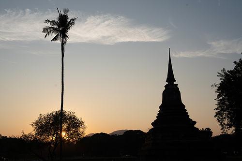 Historic Town of Sukhothai temple park, Ancient Buddha Statue at sunset Sukhothai historical park, Mahathat Temple