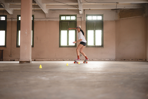 young Asian teenage girl playing skateboard, urban sport happy and fun lifestyle with skateboarding