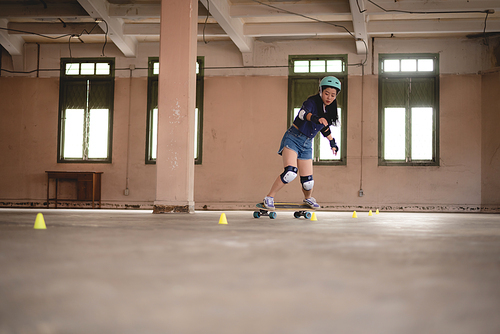 young Asian teenage girl playing skateboard, urban sport happy and fun lifestyle with skateboarding