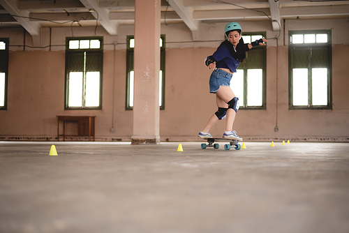 young Asian teenage girl playing skateboard, urban sport happy and fun lifestyle with skateboarding