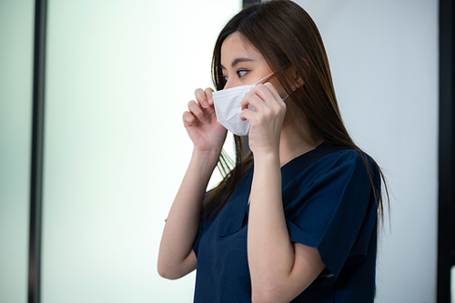 young Asian woman making treatment cosmetic beauty therapy on a face at cosmetological clinic