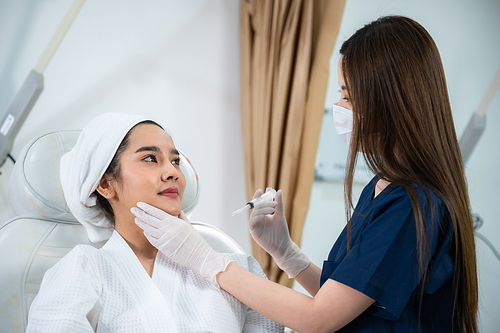 young Asian woman making cosmetology treatment skin injection, Mesotherapy of face beauty care