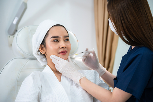 young Asian woman making cosmetology treatment skin injection, Mesotherapy of face beauty care