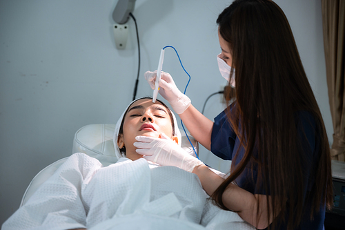 young Asian woman making cosmetology treatment skin injection, Mesotherapy of face beauty care