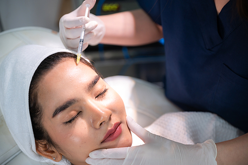 young Asian woman making cosmetology treatment skin injection, Mesotherapy of face beauty care