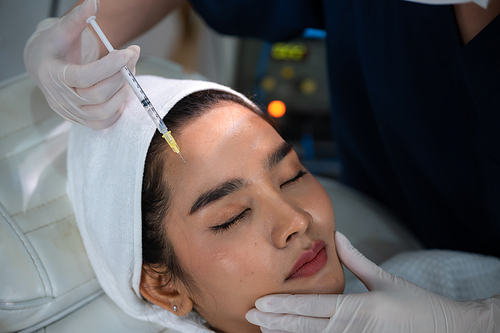 young Asian woman making cosmetology treatment skin injection, Mesotherapy of face beauty care