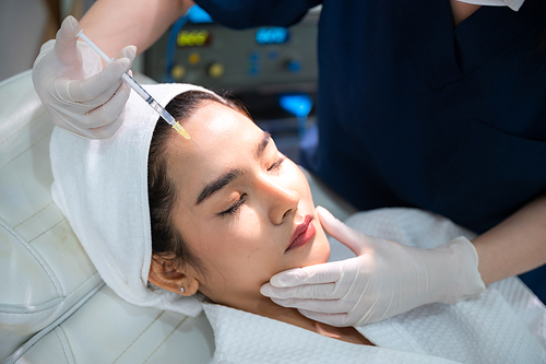 young Asian woman making cosmetology treatment skin injection, Mesotherapy of face beauty care