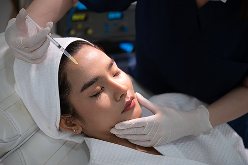 young Asian woman making cosmetology treatment skin injection, Mesotherapy of face beauty care