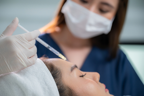 young Asian woman making cosmetology treatment skin injection, Mesotherapy of face beauty care