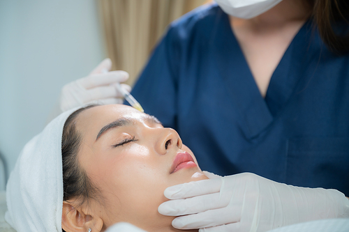 young Asian woman making cosmetology treatment skin injection, Mesotherapy of face beauty care