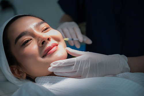 young Asian woman making cosmetology treatment skin injection, Mesotherapy of face beauty care