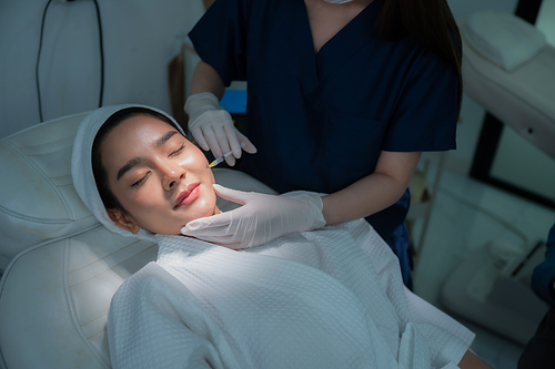 young Asian woman making cosmetology treatment skin injection, Mesotherapy of face beauty care