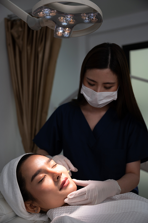 young Asian woman making cosmetology treatment skin injection, Mesotherapy of face beauty care