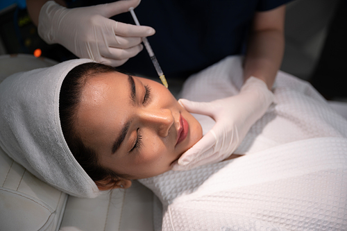 young Asian woman making cosmetology treatment skin injection, Mesotherapy of face beauty care