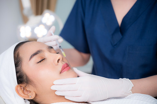 young Asian woman making cosmetology treatment skin injection, Mesotherapy of face beauty care