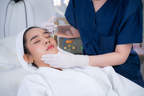 young Asian woman making cosmetology treatment skin injection, Mesotherapy of face beauty care