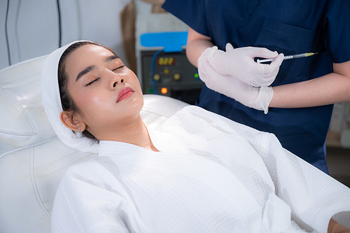 young Asian woman making cosmetology treatment skin injection, Mesotherapy of face beauty care