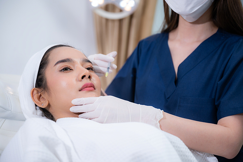 young Asian woman making cosmetology treatment skin injection, Mesotherapy of face beauty care