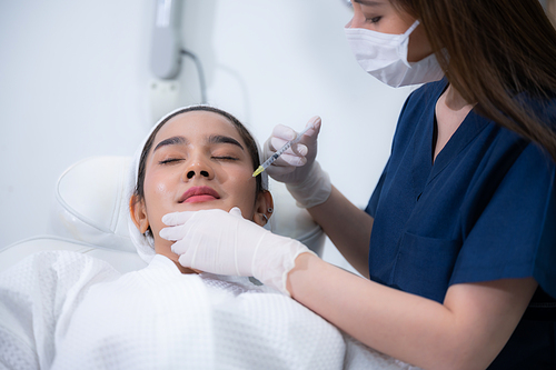 young Asian woman making cosmetology treatment skin injection, Mesotherapy of face beauty care