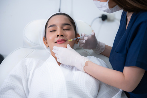 young Asian woman making cosmetology treatment skin injection, Mesotherapy of face beauty care