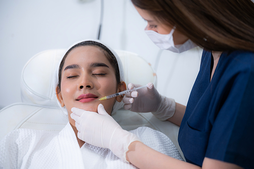 young Asian woman making cosmetology treatment skin injection, Mesotherapy of face beauty care