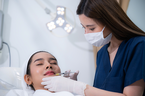 young Asian woman making cosmetology treatment skin injection, Mesotherapy of face beauty care