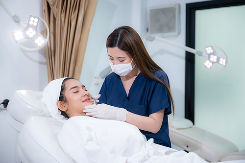 young Asian woman making cosmetology treatment skin injection, Mesotherapy of face beauty care