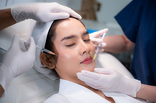 young Asian woman making cosmetology treatment skin injection, Mesotherapy of face beauty care