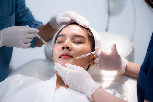 young Asian woman making cosmetology treatment skin injection, Mesotherapy of face beauty care