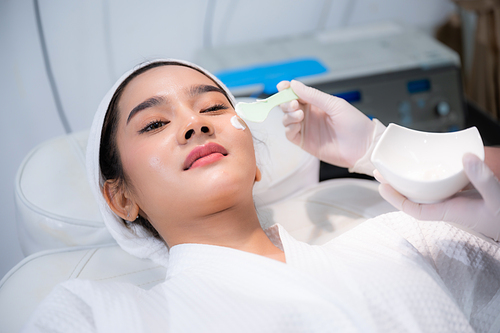 young woman patient with a therapy treatment of cosmetic face skin, surgery medicine concept