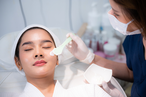 young woman patient with a therapy treatment of cosmetic face skin, surgery medicine concept