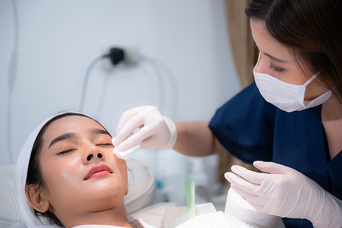 young woman patient with a therapy treatment of cosmetic face skin, surgery medicine concept