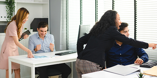 Employee business man give flip chart presentation to smiling colleagues at negotiations, workers laugh at office meeting, man present project or idea to happy coworkers at briefing