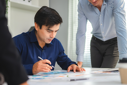 Serious diverse business team leader discuss financial paperwork, Smart businessman and businesswoman partner teamwork talking discussion in group meeting at office table in modern office interior