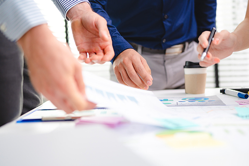 Employee business man give flip chart presentation to smiling colleagues at negotiations, workers laugh at office meeting, man present project or idea to happy coworkers at briefing