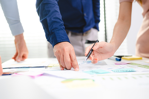 Serious diverse business team leader discuss financial paperwork, Smart businessman and businesswoman partner teamwork talking discussion in group meeting at office table in modern office interior