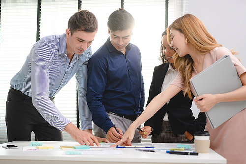 Serious diverse business team leader discuss financial paperwork, Smart businessman and businesswoman partner teamwork talking discussion in group meeting at office table in modern office interior