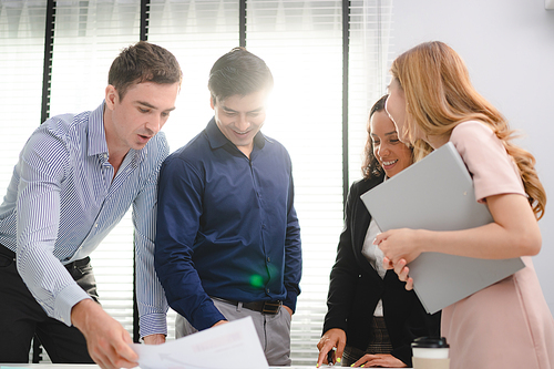 Serious diverse business team leader discuss financial paperwork, Smart businessman and businesswoman partner teamwork talking discussion in group meeting at office table in modern office interior