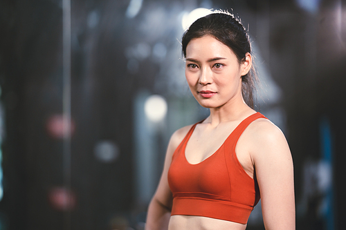 young Asian woman person exercise in fitness gym for building a beautiful slim body, healthy training of athletic female in sport lifestyle, attractive girl doing weight active wellness in happy