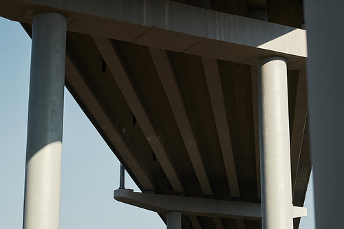 Concrete poles of contemporary bridge supporting deck outdoors