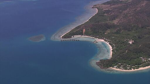 맑고 푸른 태평양 섬 주변 바닷가에 수상 리조트가 보이는 항공 촬영 영상